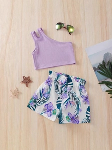 Girls summer two-piece set with purple ribbed tank top and floral shorts on wood background