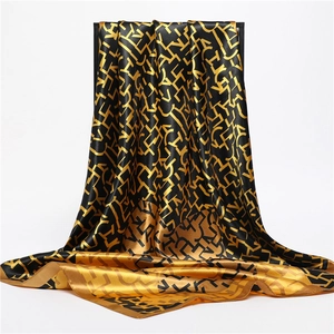 Elegant black and gold silk-feel square scarf featuring geometric letter pattern