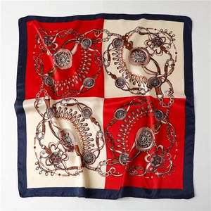 Macro shot of satin silk square scarf with vintage equestrian chain and harness patterns