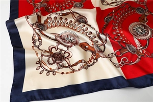 Detail of satin square scarf featuring vintage equestrian chain and jewel print patterns