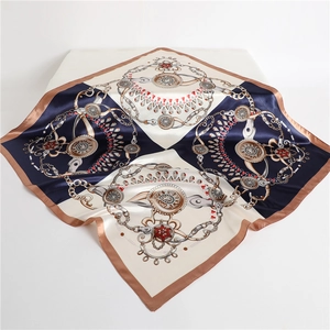 Detailed view of the luxury chain and jewel print on a large satin square silk scarf