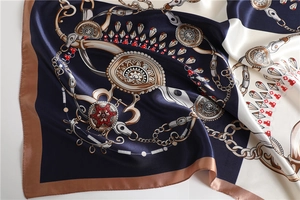 Detailed view of satin square scarf with chain pattern and smooth silk texture