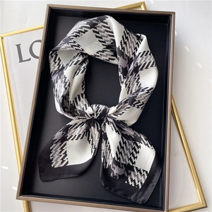 Close-up of classic houndstooth silk scarf with elegant black and white pattern texture