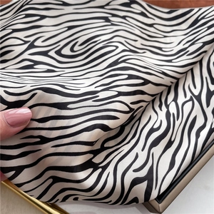 Macro shot of zebra pattern silk scarf showing soft texture and premium draping quality