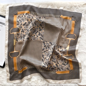 Detail of silk square scarf featuring paisley patterns and houndstooth texture