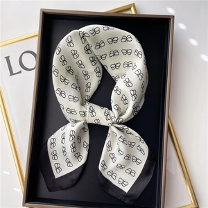 Elegant 70cm square silk scarf with butterfly print and black border on a tray