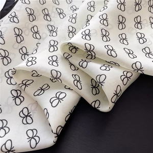 Macro shot of elegant butterfly print on white silk fabric with luxury satin finish
