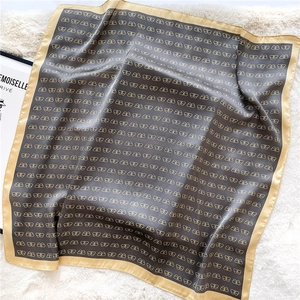 Detailed macro view of brown and gold butterfly pattern on elegant satin silk scarf