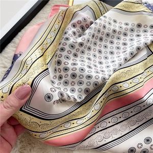 Detailed macro view of the silky lace paisley scarf with vibrant colored striped edges