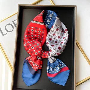 Silk feel square scarf with red and blue paisley print tied on a tray for decoration