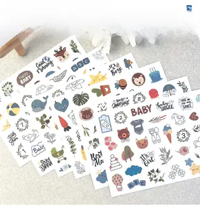 Detailed close-up of four sheets of cute baby milestone stickers with animal illustrations