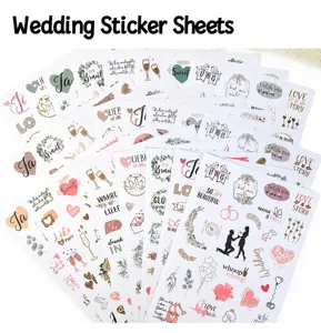 Close-up of German and English wedding scrapbooking stickers with floral and heart motifs
