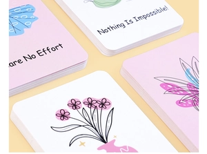 Vista macro di 60 carte motivazionali con disegni floreali e angoli arrotondati