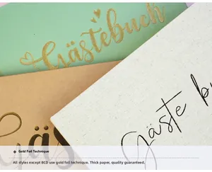 Close-up of linen guest books with gold stamping and high-quality thick paper textures