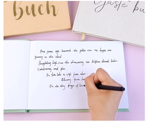 Macro view of writing on premium white paper of a linen wedding guest book