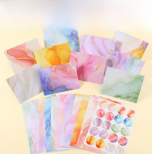Detail of marble pattern stationery set including colorful envelopes, paper, and stickers
