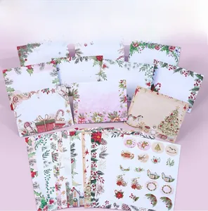 Detailed Christmas stationery set with floral envelopes, writing paper, and round stickers