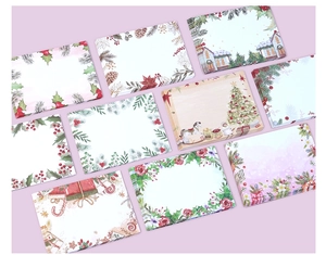 Flat lay of watercolor Christmas stationery set featuring floral borders and winter motifs