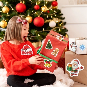 Christmas stickers set with Santa and reindeer on gift box by holiday tree