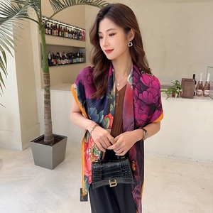 Detail of silk satin scarf with floral pattern draped elegantly on an Asian model