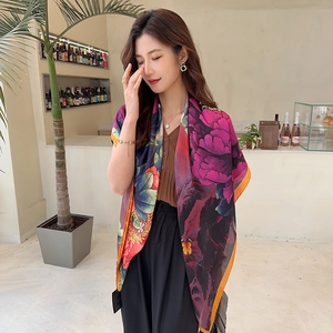 Detail of a 110cm silk-satin scarf featuring vibrant peony floral prints and butterflies