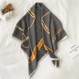 Luxury square silk scarf featuring black white houndstooth pattern and golden chain print