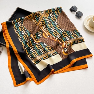 Detail of luxury silk scarf with chain patterns and high-gloss satin texture