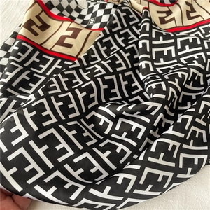 Detailed view of the luxury silk scarf with FF monogram pattern and colorblock edge