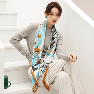 Detail of a large silk scarf showing modern architecture patterns on smooth satin fabric