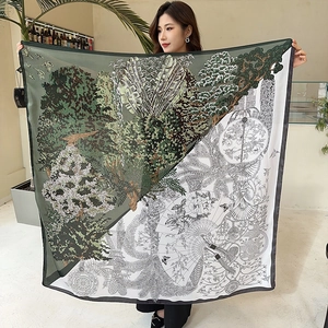 Macro detail of a 110cm silk square scarf showing diagonal split color and nature patterns