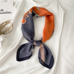 Elegant chain pattern silk scarf with orange and grey contrast design on white dress
