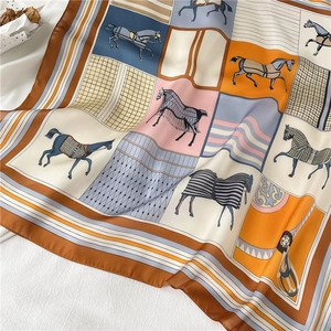 Detail of luxury silk-like scarf with equestrian horse print and rolled edges