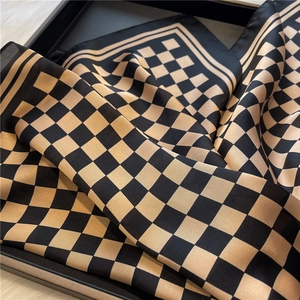 Detail of checkered faux silk scarf in black and bronze with smooth satin luster