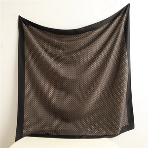 Close-up of silk texture square scarf with vintage geometric patterns and black border