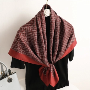 Elegant dark red silk square scarf with vintage floral patterns tied on a black outfit