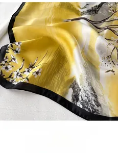 Detail of yellow flower pattern silk scarf with black borders and smooth ink texture