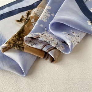 Detailed view of the smooth floral silk scarf featuring cherry blossom patterns and rolled edges