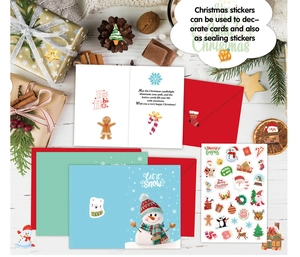 Close-up of festive Christmas stickers, holiday cards, and red envelopes on white wood