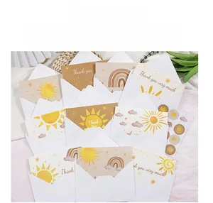 Bohemian thank you cards with envelopes featuring sun and rainbow designs on fabric background