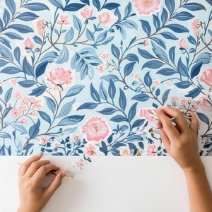 Detail of floral pattern scrapbooking paper being cut with DIY crafting tools