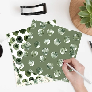 Scrapbook paper sheets with green watercolor dots for forest theme crafts and DIY decor