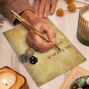 Close-up of vintage A5 scrapbooking paper with a golden metal pen and textured gaming dice