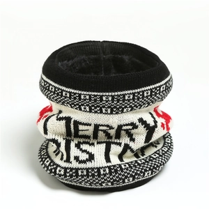 Close-up of a Christmas knit scarf with plush fleece lining and festive reindeer patterns