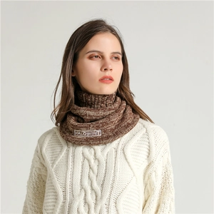 Detailed texture of brown thick-knit neck warmer with embroidered logo label