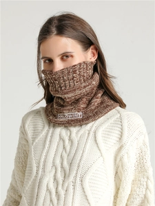 Detail of knitted neck gaiter with rib texture and HALOWINT embroidered patch label