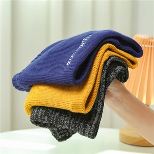 Three colors of ribbed knit beanies in navy, yellow, and grey with fashion embroidery