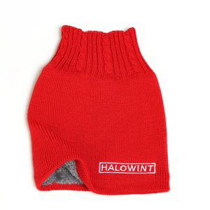 Detail view of red cable knit neck warmer with thick grey fleece lining and HALOWINT embroidery