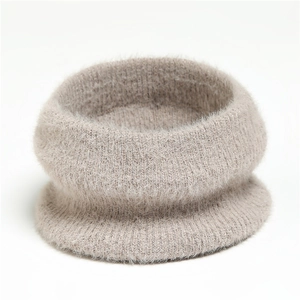 Close-up of soft khaki faux mink fur neck warmer with thick plush knitted texture