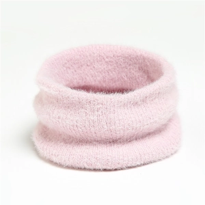 Close-up of soft pink knitted mohair neck warmer with fuzzy texture for winter warmth