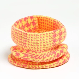 Detailed view of the yellow and pink houndstooth knitted pattern on the thick neck warmer